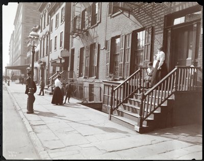 Women and children on and near the stoop of the National Fruit and Flower Guild, 247 Spring Street by Byron Company